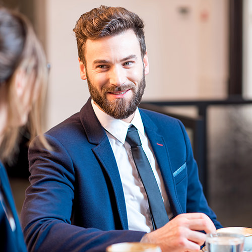 Professional male chatting with colleague