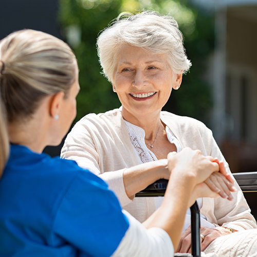 Elderly patient being comforted by medical staff