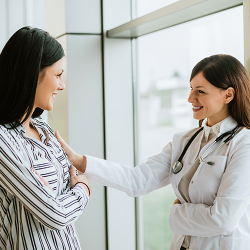 Female medical consultant speaking to a colleague