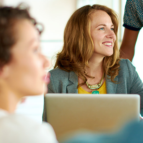 Young lady using laptop in work environment