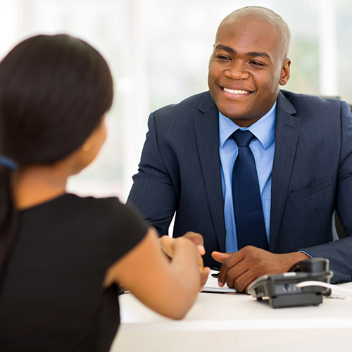 Employer shaking hands with another colleague