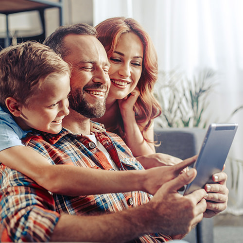 Happy family looking at tablet device together