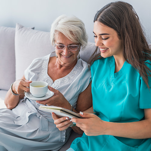 Medical care professional reviewing paperwork with a patient