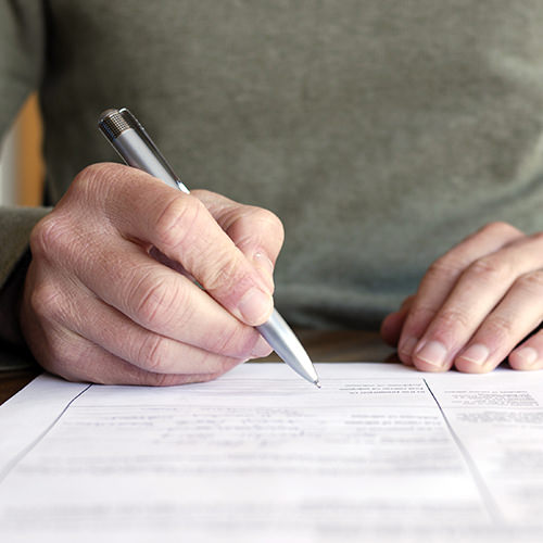 A male reviewing and filling out forms