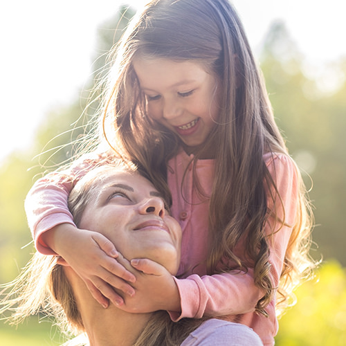 Mother and daughter smiling at each other