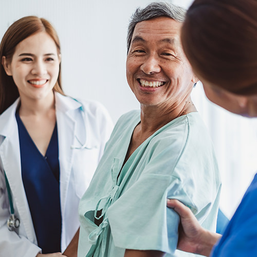 Patient speaking to medical staff and consultant