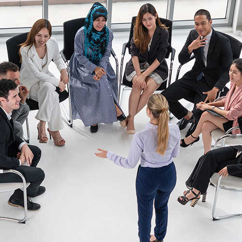 Professional work group with person presenting to them